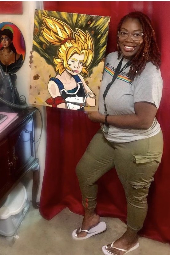 Nika B holding her golden-haired anime portrait painting