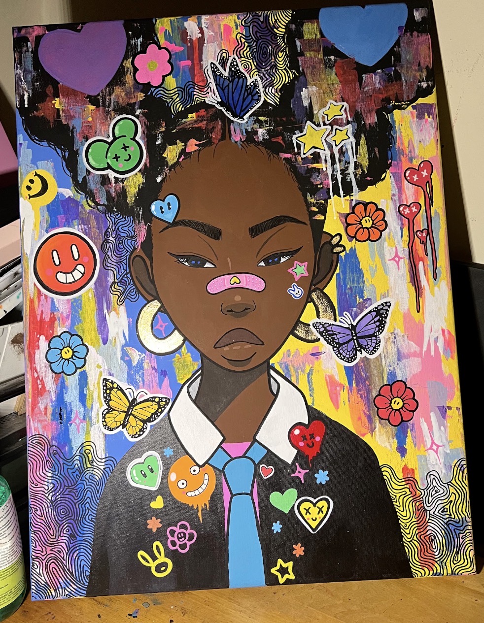 Painted girl in a tie surrounded by butterflies, flowers, hearts and colorful marks