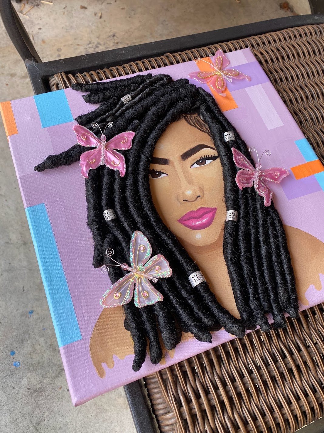 Commissioned portrait with textured braids and pink butterfly embellishments