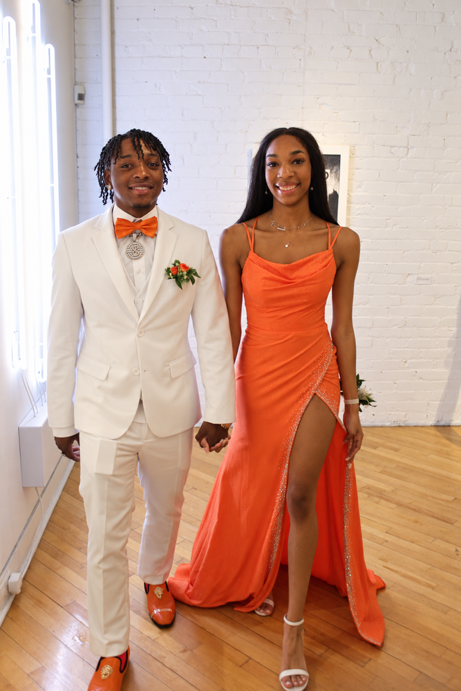 Prom couple in orange and white photographed by Nika B